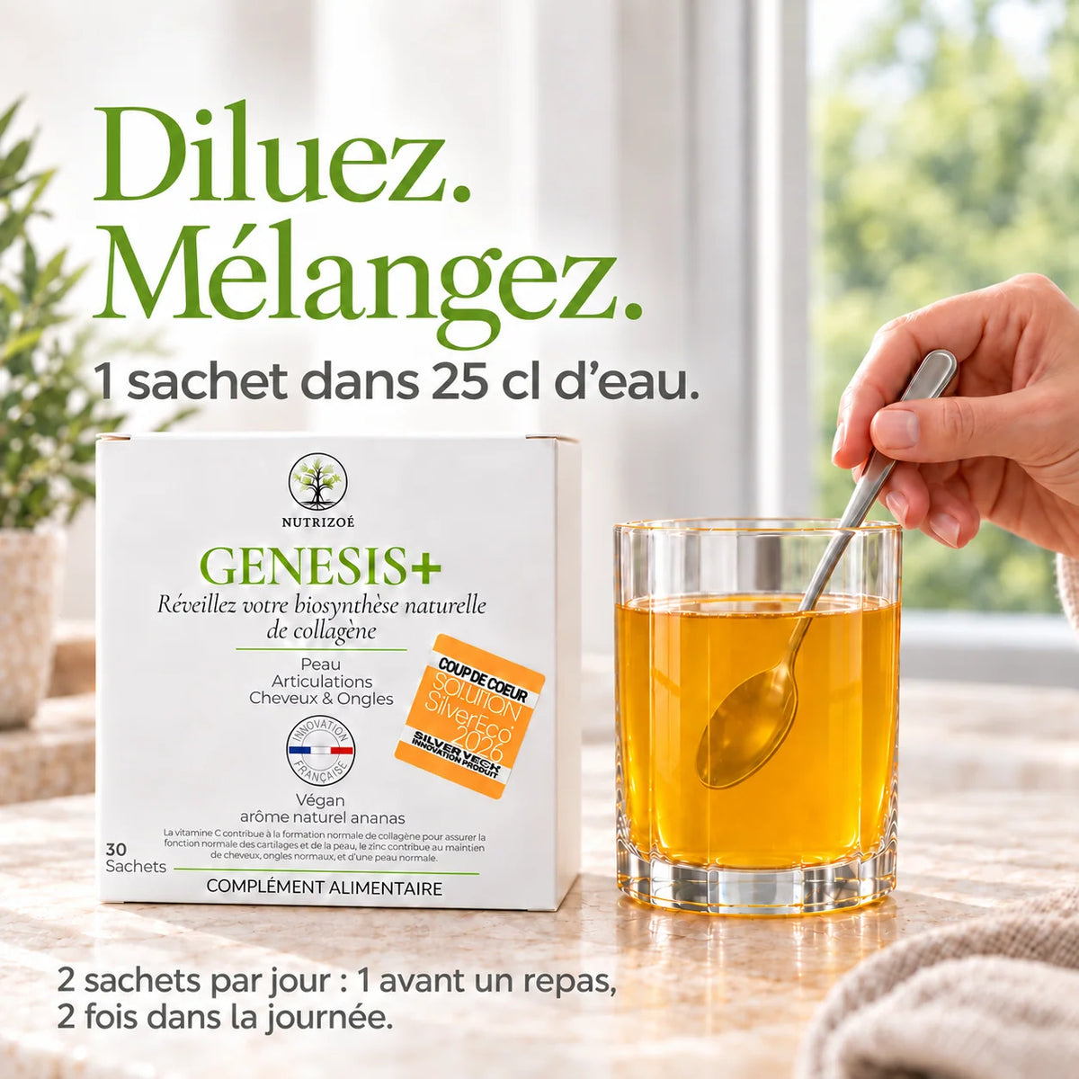 A hand holding a spoon stirs GENESIS+ in an angular glass, next to the box.